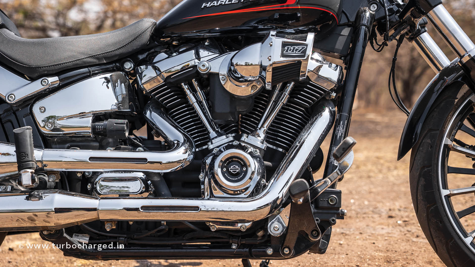 The Harley-Davidson Breakout is the kind of motorcycle that requires a little effort to understand, particularly as a potential owner. But it takes zero effort to understand as an onlooker. This dichotomy of the purpose of this motorcycle made me scratch my head a bit, but after riding it around the city and the highways for a couple of days, it became clear. This is the story of my journey to finally understanding the purpose of a motorcycle that doesn't make much sense on paper, except lives are not lived on paper, either. 
But before we dive into it, a little backstory: the Breakout name first appeared on the Harley-Davidson catalogue back in 2013. However, that was not the first time Harley-Davidson created a ‘factory custom,’ that honour goes to the Rocker C, which came out in 2008. These ‘factory custom’ motorcycles followed the custom chopper design language, which comprises a kicked-out front fork with a lazy rake (the Breakout measures at 34°), fat tyres (the rear tyre on the Breakout is a 240-section), and minimalist instrumentation (Breakout has one of the smallest instrument clusters ever fitted to a production motorcycle, I swear). After discontinuing the Rocker, Harley launched the Breakout. It initially had the 103CI engine (1,690cc), which grew to the 117CI (1,923cc) in 2023, producing 104PS and 168Nm. That torque number is higher than most midsize cars on sale in India, proving once again there really is no replacement for displacement. 
Which tells us that big and large, however crude, will always have an advantage. And that essentially defines the motorcycle. That being said, Harley-Davidson engineers are some of the best in the world, and as a result, the Breakout does things you wouldn’t expect it to. The 310kg kerb weight is only felt when trying to push the bike uphill, as the aforementioned wave of torque makes short work of the job of propulsion. The Breakout surges ahead with every twist of the throttle, and the air-cooled V-Twin provides the soundtrack of hundreds of escapist fantasies that were committed to the silver screen.
Despite having a wheelbase of 1,695mm, the turning circle is way smaller than expected and causes the same surprise when oil tanker captains are handed the keys to a tugboat. While the rake makes steering slow, it also makes it stable, aided by the county-spanning wheelbase. The chunky rubbers at both ends provide oodles of grip, even on less-than-ideal surfaces. Also, the front brake is quite effective, but like any proper cruiser, both brakes need to be used in tandem to get the best out of the retardation system (the rear brake’s actuation is impeded a bit by the air filter that juts out defiantly). 
One issue is the ground clearance, which is, for all intents and purposes, non-existent. Some speedbreakers will force a diagonal maneuver, and steep driveways and gas station entryways will require proper strategising in advance. Speaking of learning the peculiarities of a motorcycle, the unique switchgear did take some getting used to, but it was easier than the horn and turn signal, with positions reversed as can be found on some modern Japanese motorcycles. Also, the separate left and right turn signal switches were quite intuitive, while the engine kill and starter being on separate switches were still easy to use, as a single thumb press was all it needed to actuate those. The minimalist console was highly informative, and the separate panel below it with the tell-tale lights conveyed what the console couldn’t. On a personal note, I wish more manufacturers would design beautiful LCDs like the one on the Breakout, instead of unnecessary TFT displays, which are often more distracting than both LCDs and analogue clocks. 
It is so long that whenever it is parked next to other two-wheelers, the tail sticks out by about a foot; it has such a tall gearing that in city traffic you will rarely have a rendezvous with the 4th gear; the noise is deafening and attracts dirty looks from the morning walkers as you thunder past them, trying your best not to look smug. But, despite it being a super-expensive motorcycle, it never got on people’s nerves, unlike a typical Japanese/European superbike. The chrome and black Harley was not designed to break speed records and terrorise other road users; it was made to make the rider feel good. Yes, cruisers are not meant to be the most efficient at anything; their motto in life is different. This is where the Breakout is well-nigh unbeatable. I received way more thumbs-ups astride the Breakout than I had in any other motorcycle ever, and I have ridden a fair few in the last two-and-a-half decades. It somehow spreads joy around, even when you occasionally whack the throttle open and draw a few glances. Maybe because, despite the performance on tap, the Breakout manages to produce more drama than forward motion, which makes it less of an instrument and more of a toy. 
And that’s exactly what it is. Admittedly, a very expensive toy, but a toy nevertheless. This is palpable to other road users and passers-by, which has a profound effect on how the motorcycle, and consequently the rider, is perceived by the masses. When you are aboard a crotch-rocket, all they see is a grown man pretending to be a kid; but onboard the Harley-Davidson Breakout, you are a kid — no pretensions. The people may get a bit annoyed at the booming exhaust, but that amounts to no more than a kid playing with a noisy toy — people tune it out because no one is usually cruel enough to take toys away from kids. And we don’t need to discuss mundane things like price tags for items that spread joy around, like a Harley-Davidson Breakout.

